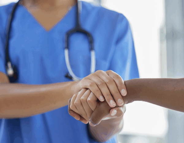 Une médecin tient la main d'une patiente